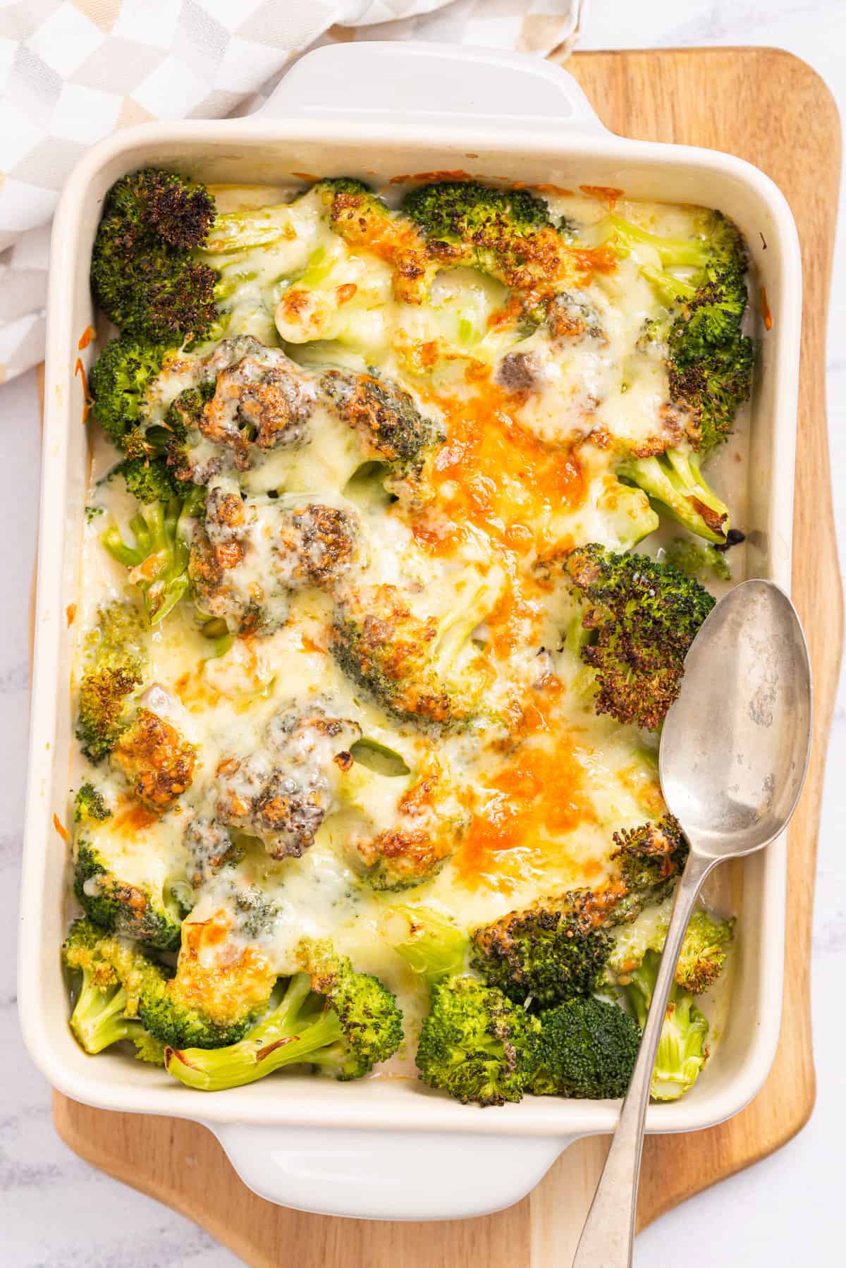 An overhead image of broccoli cheese casserole with a spoon resting on the lower left side.