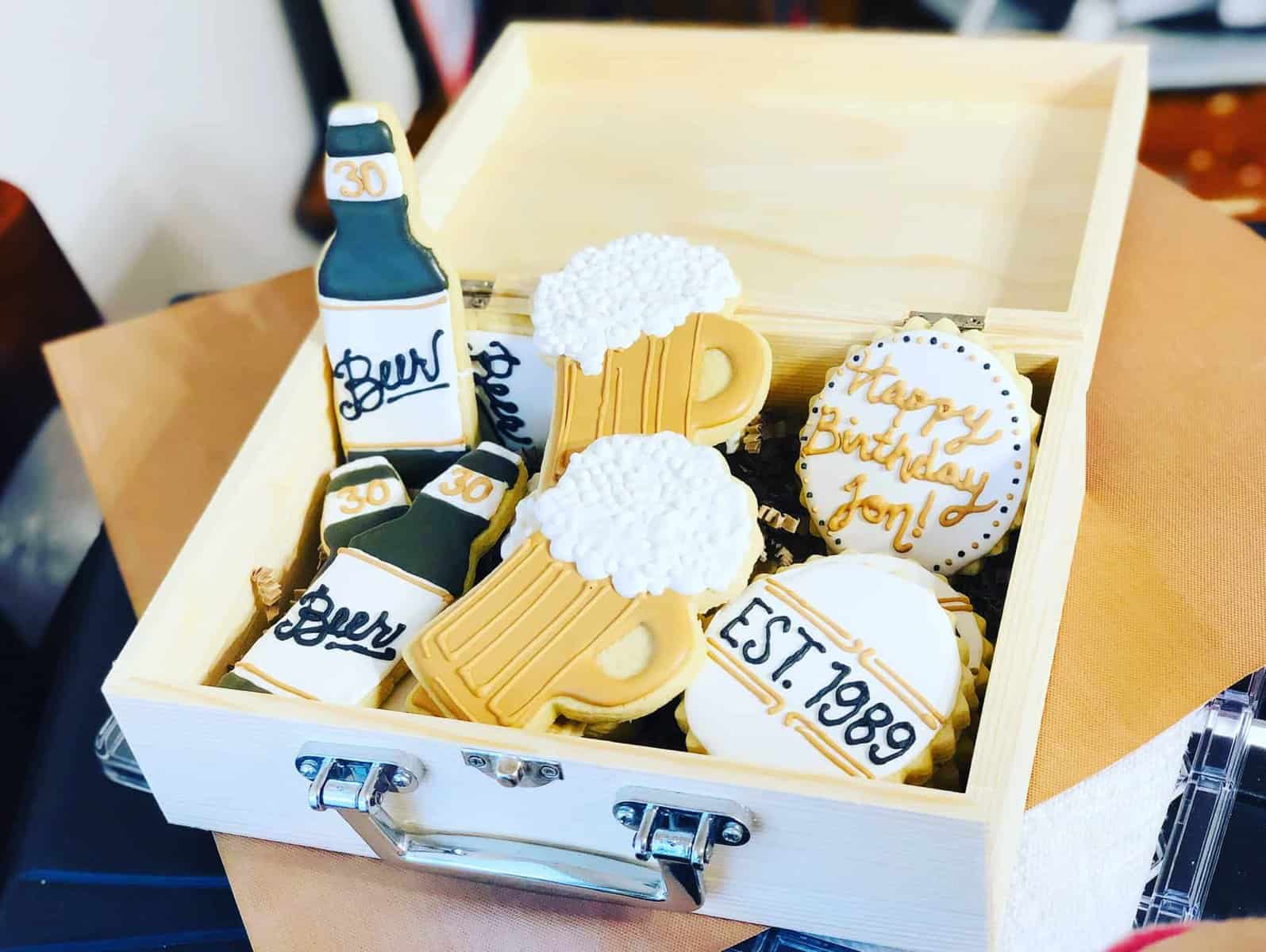 Overhead view of a wooden box filled with beer theme vegan & gluten free sugar cookies.