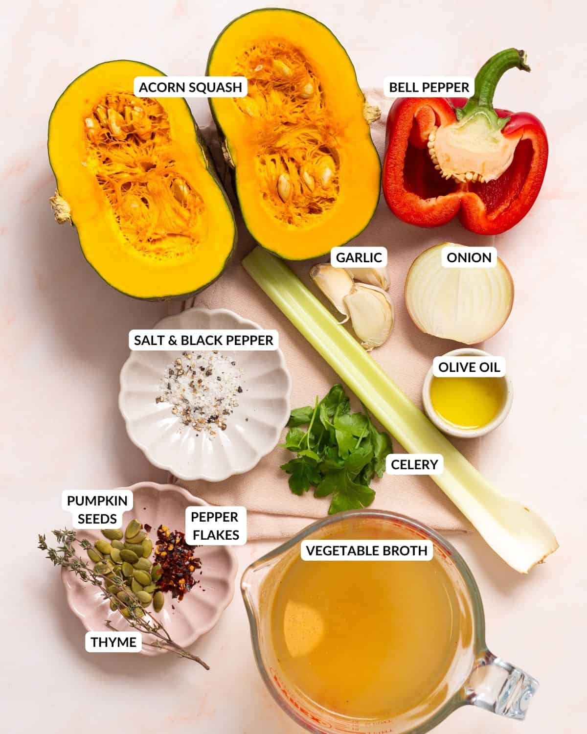 An image of the ingredients of acorn squash soup arranged side by side on a table with labels.