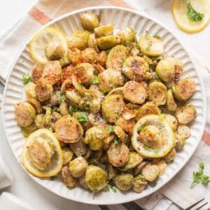 Air fryer Brussels sprouts served with lemon and herb.