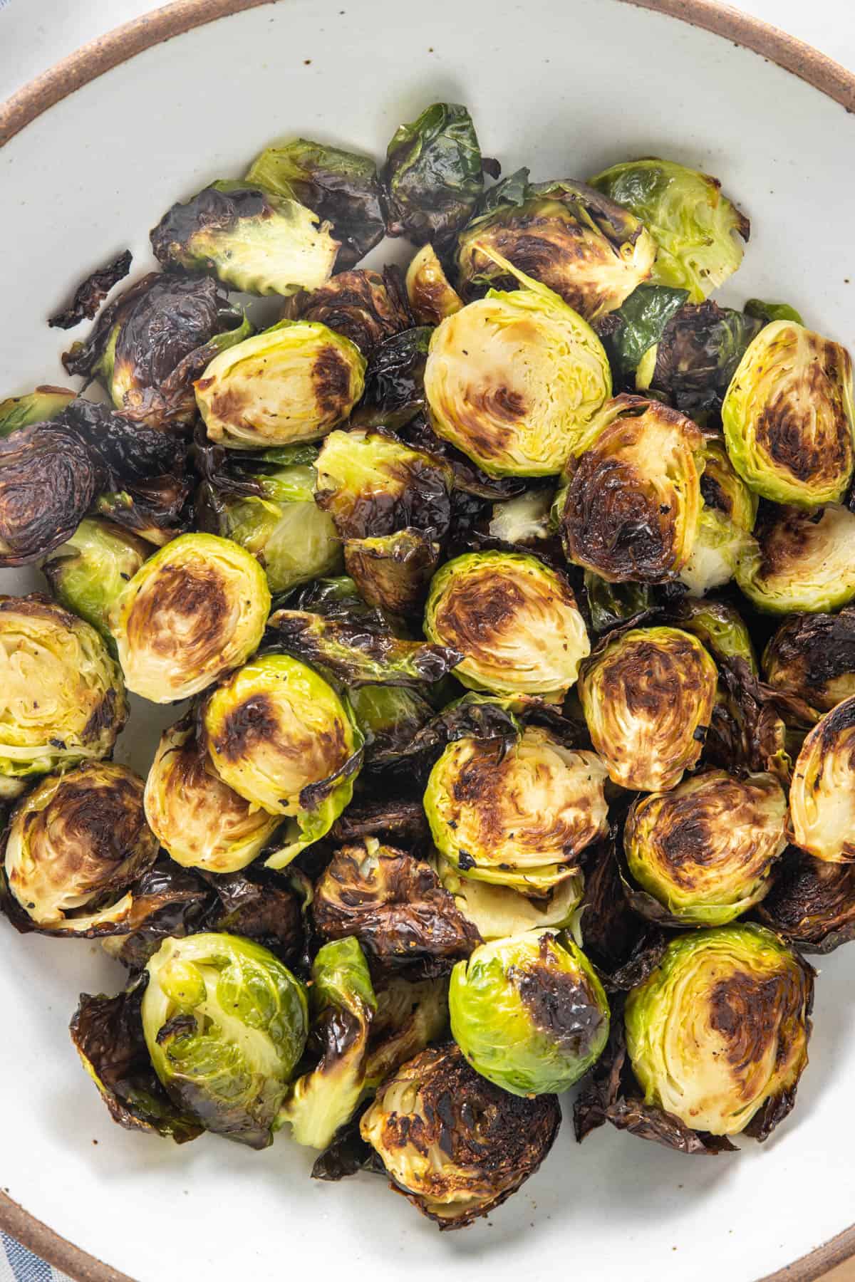 Close up of bowl of air fried brussels sprouts in a bowl