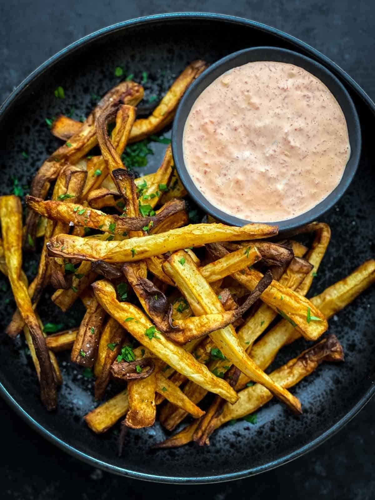 Close up of parsnip fries in the air fryer basket