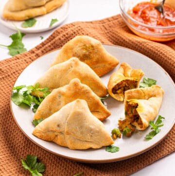 An image of air fryer samosas on a plate that's ready to be served.