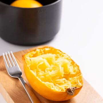 An image of spaghetti squash with strands and a fork on the side.