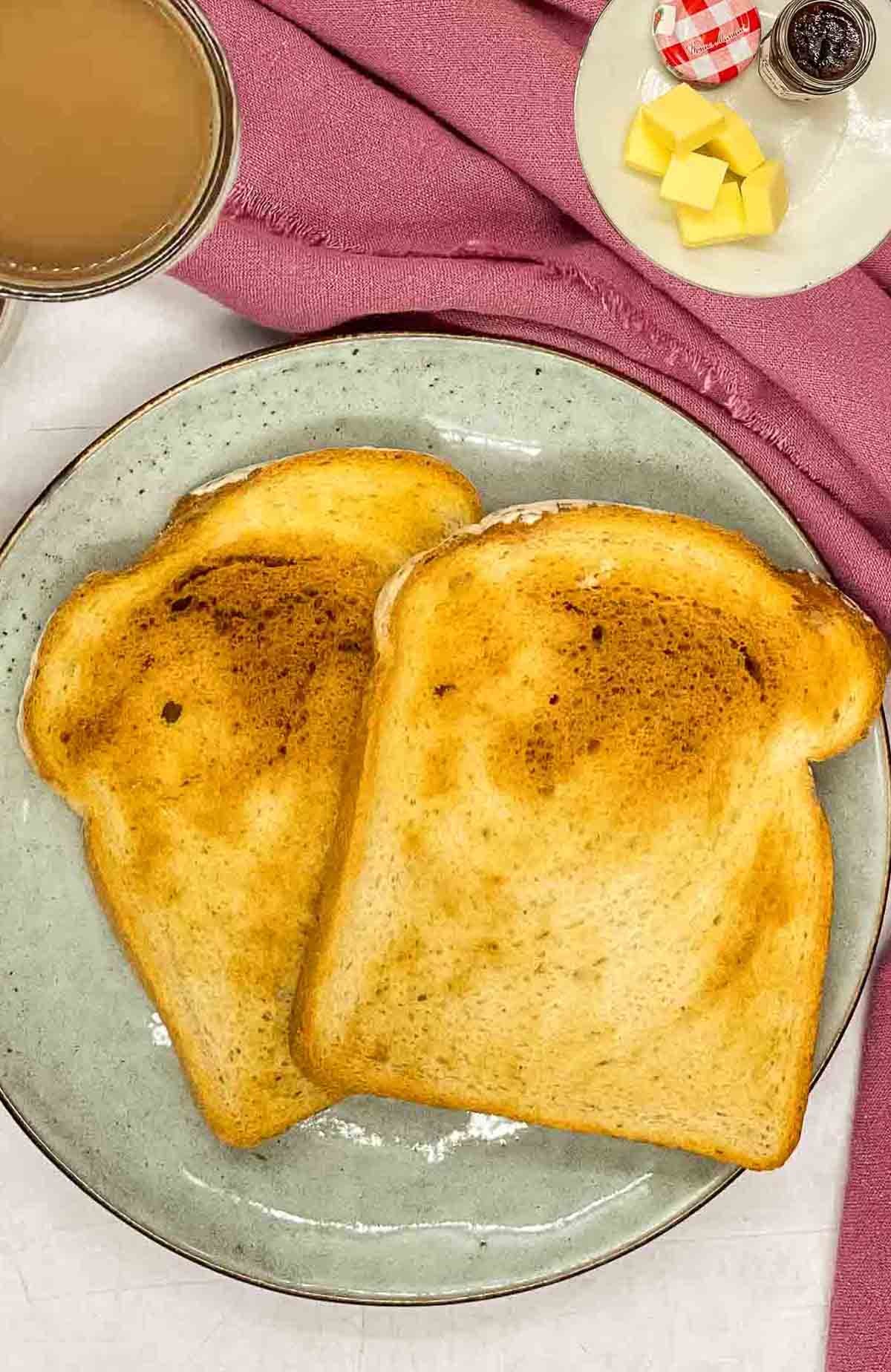 Overhead view of two sliced air-fried toasts placed on a plate.