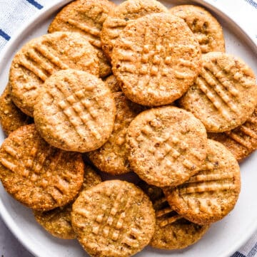 Close up of almond flour peanut butter cookies on a white plate.
