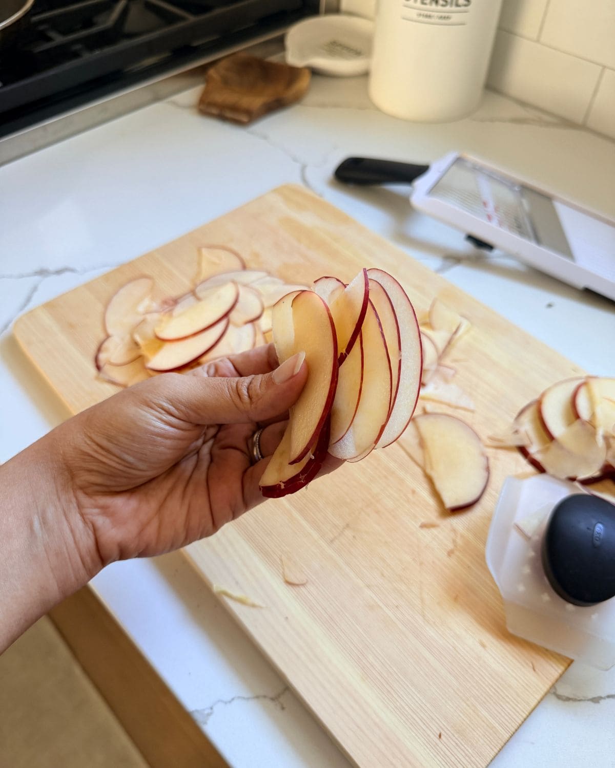 Apple sliced thin using mandoline for tart.
