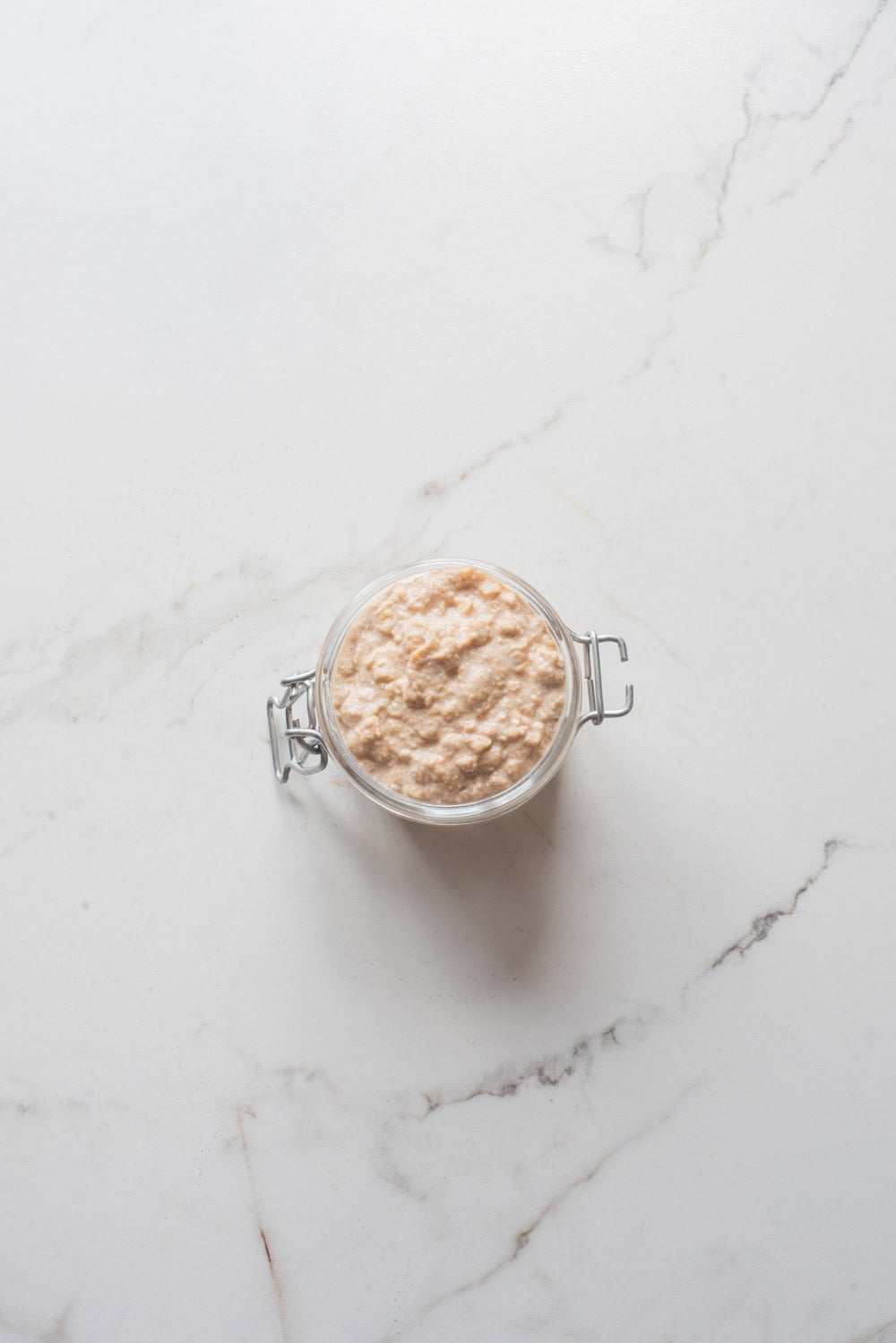 Apple pie chia overnight oats without toppings in a jar.