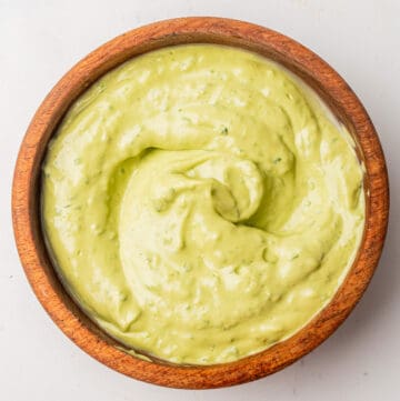 An overhead image of avocado cilantro lime dressing in a bowl.