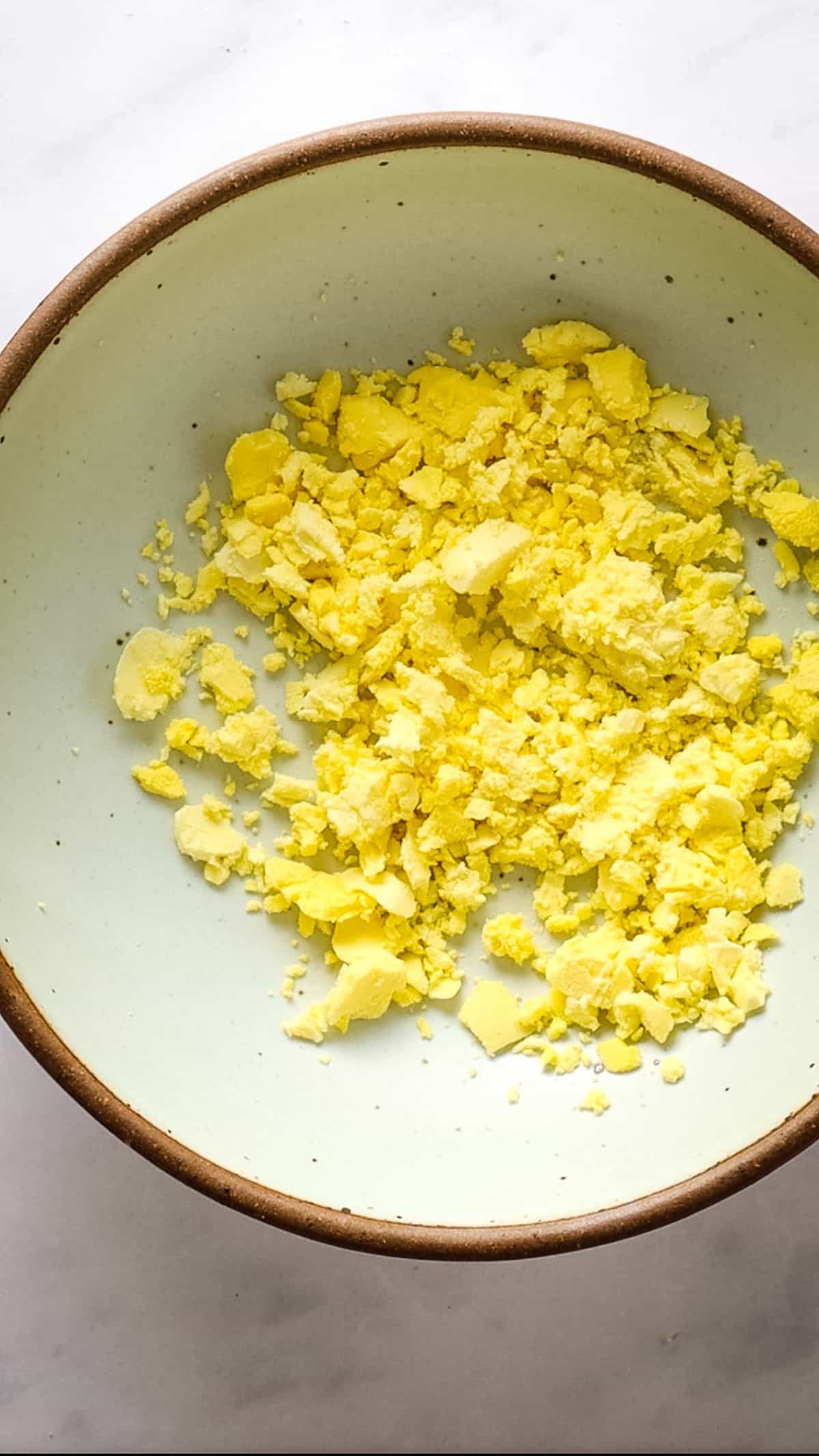 Close up of mashed yolks in a bowl
