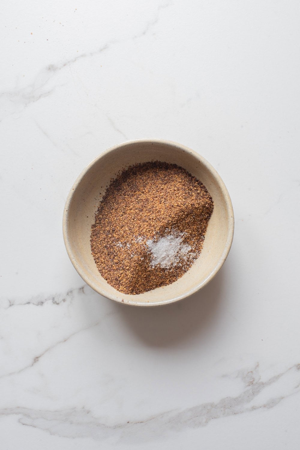 Ground brown mustard seeds and salt in a bowl for making senafich Ethiopian mustard.