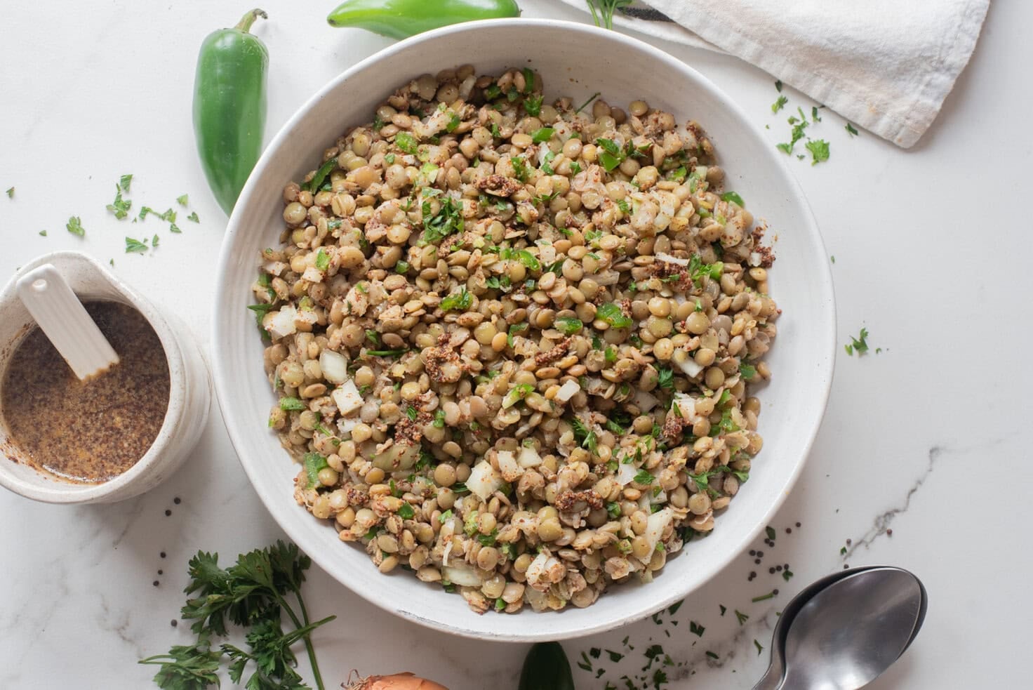Top view of Ethiopian lentil salad azifa served in a white bowl.