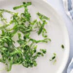 Close up image of basil chiffonaded on a plate