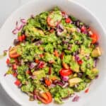 An overhead image of black bean salad drizzled with cilantro lime dressing in a bowl.