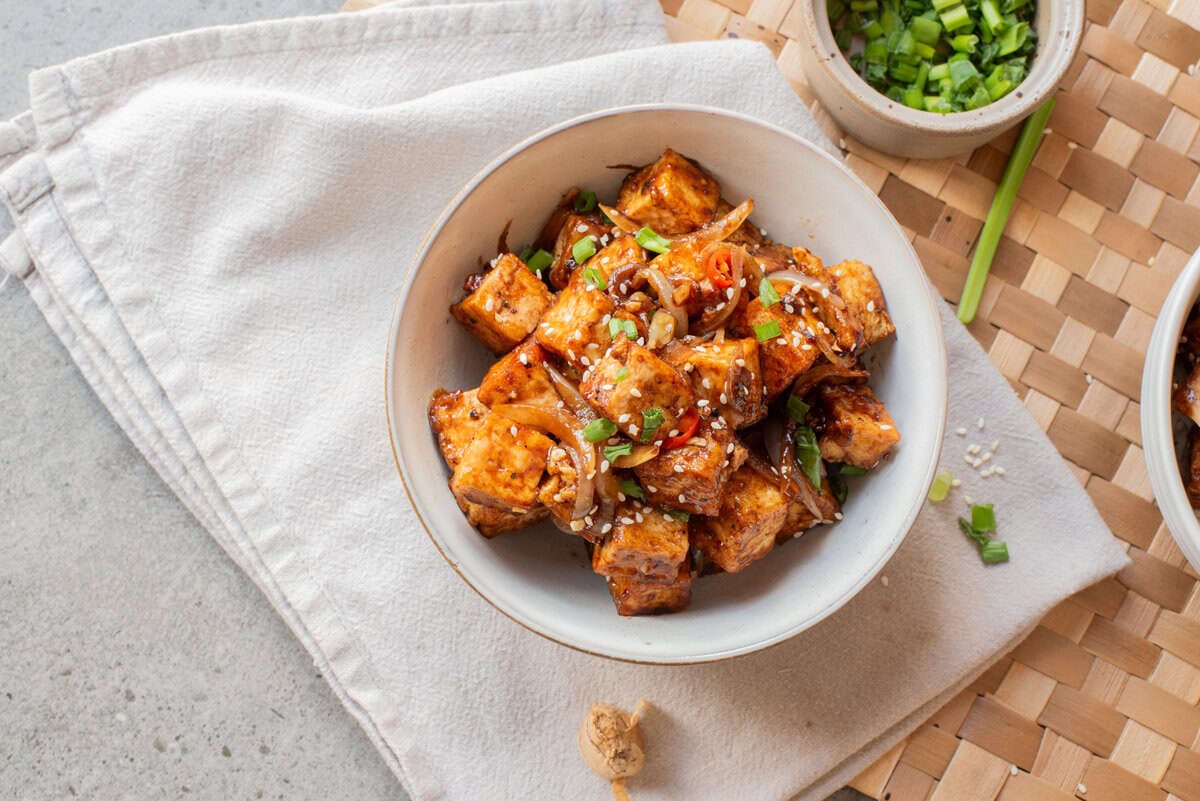 An overhead image of black pepper tofu in a bowl.