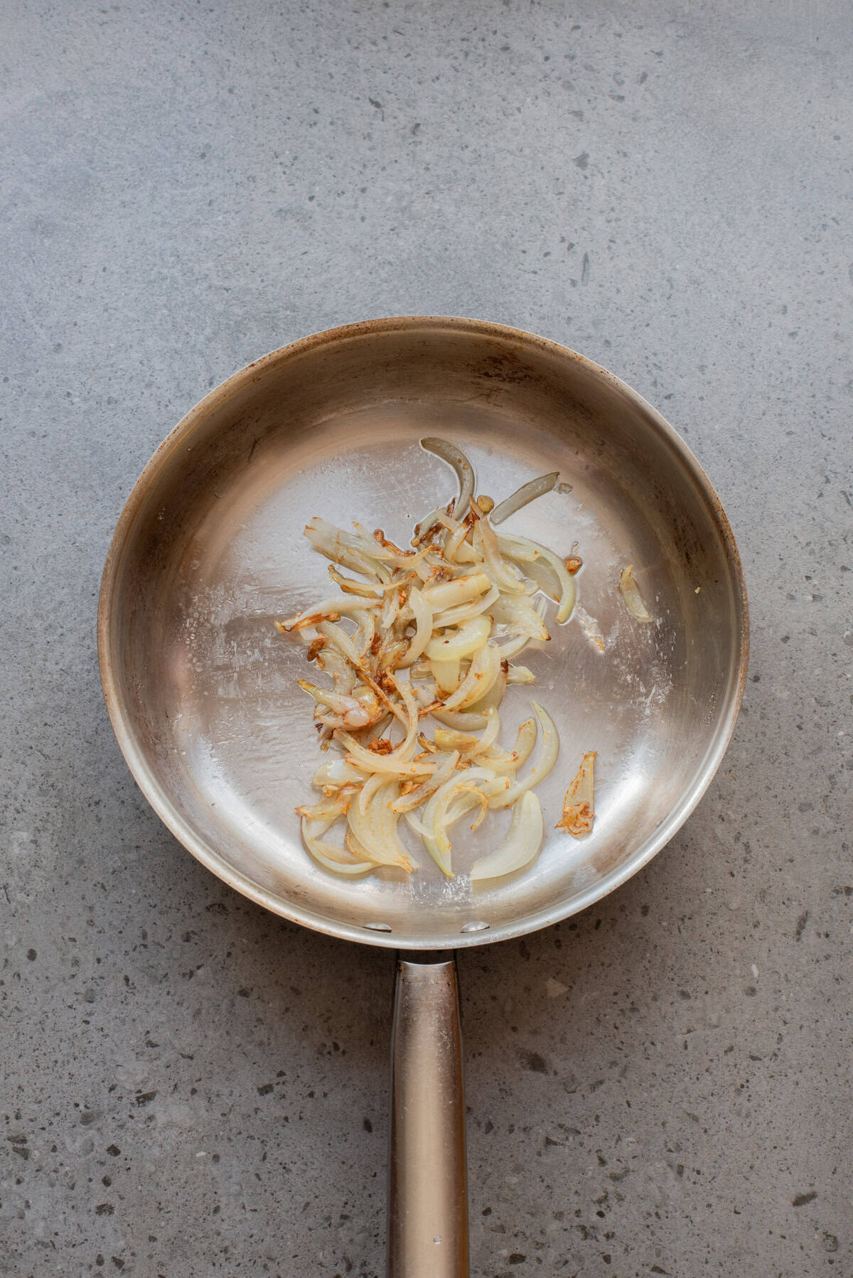 An overhead image of sauteing the onions and garlic in a skillet.
