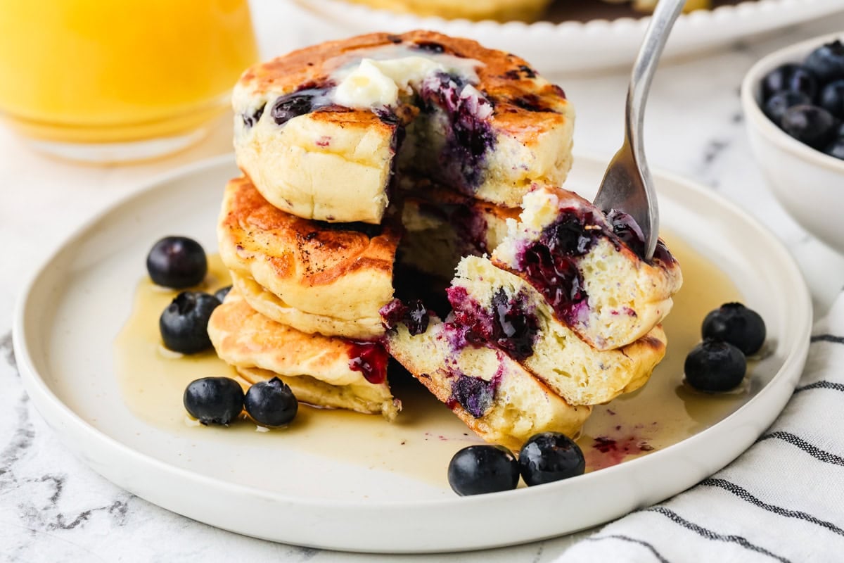 An image of slicing into a stack of pancakes.