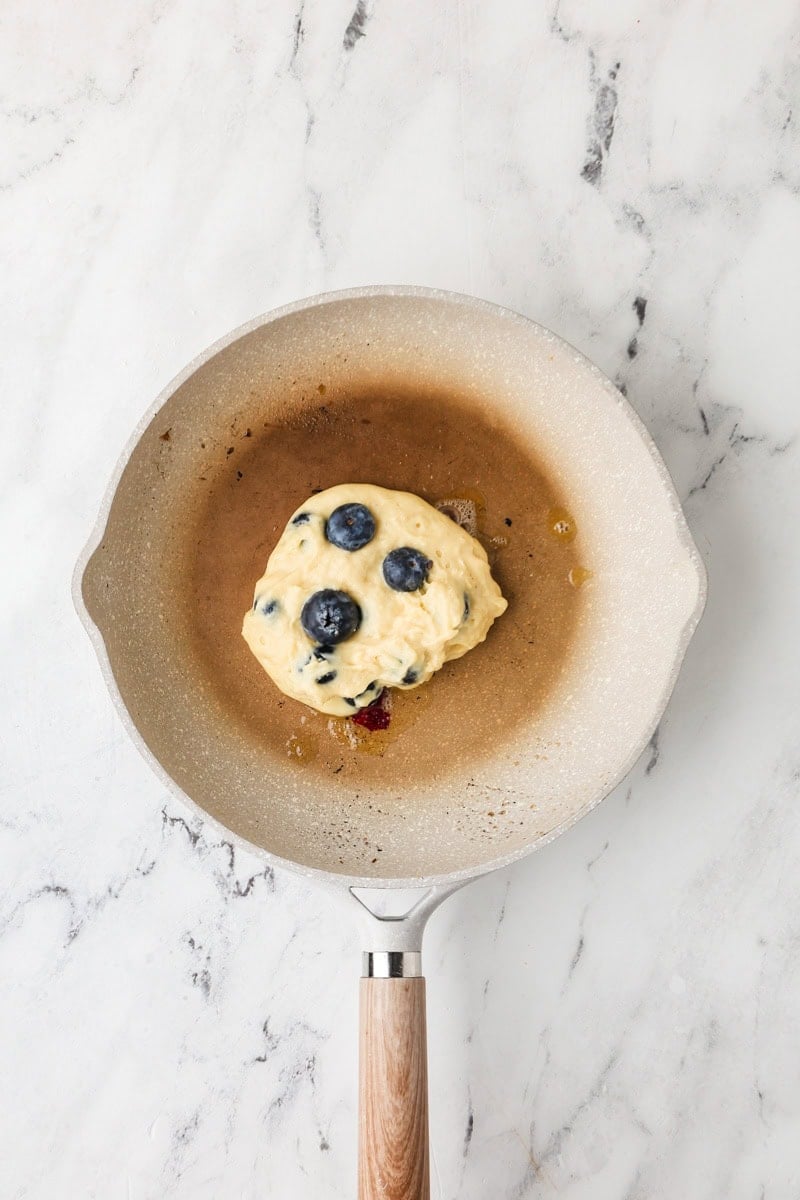 An overhead image of cooking the pancakes in a pan.