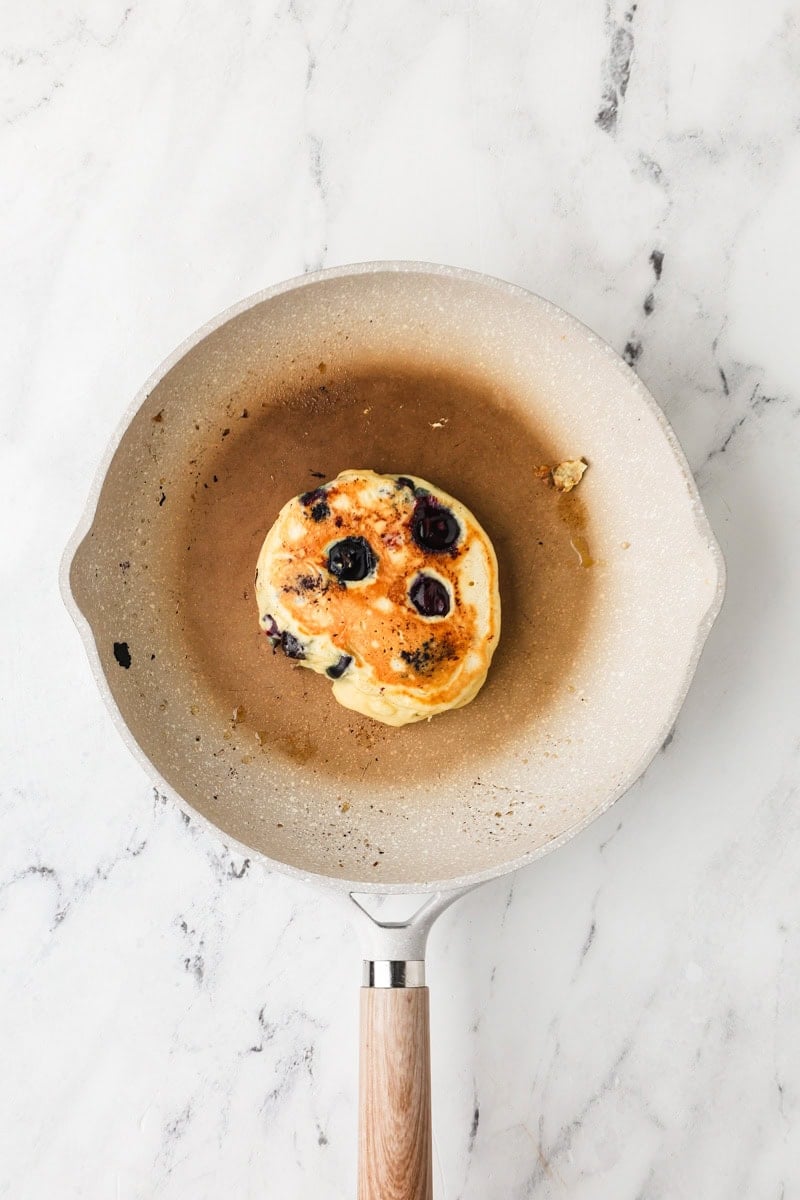 An overhead image of flipping the pancakes.