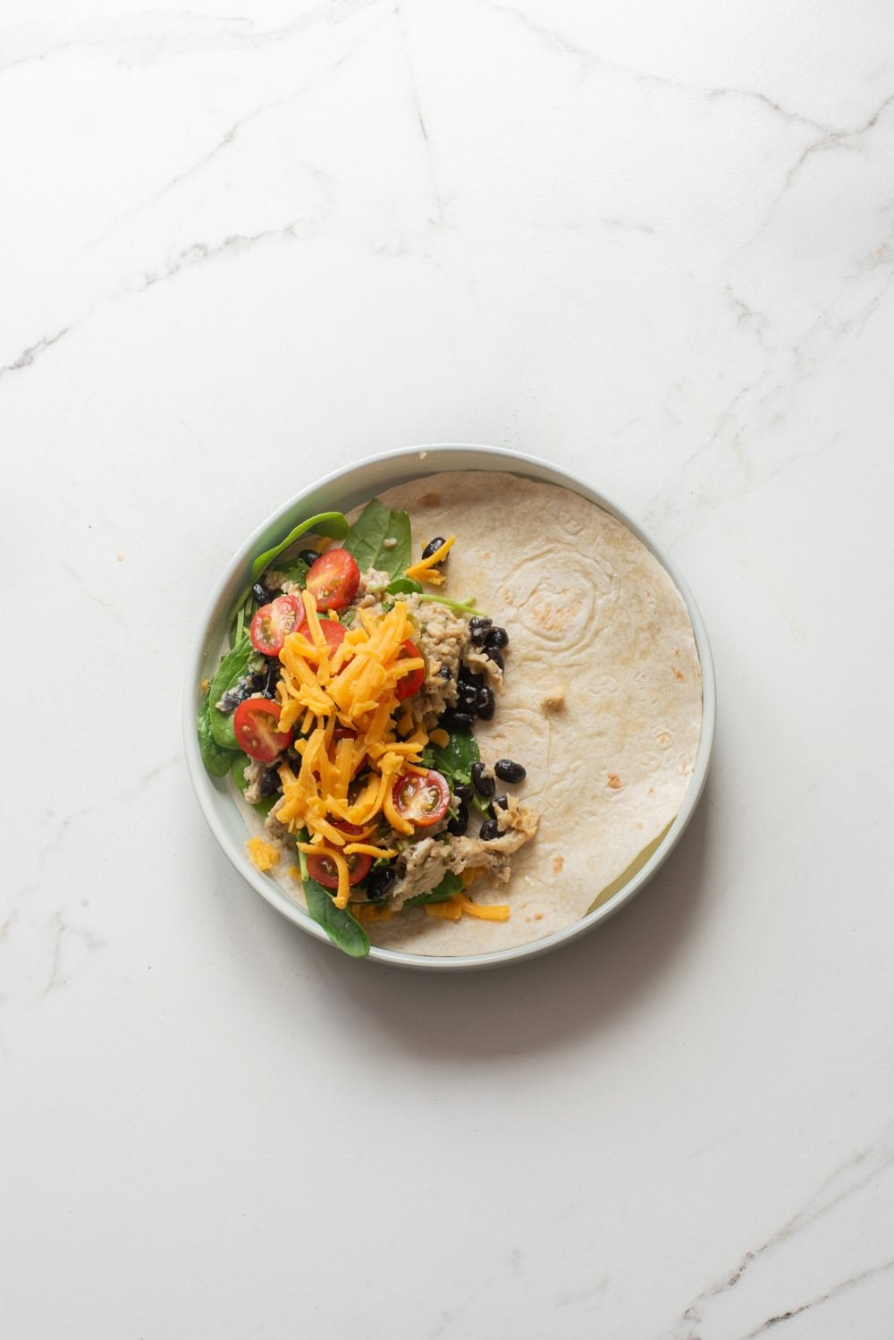 An overhead image of assembling the vegetarian quesadilla.