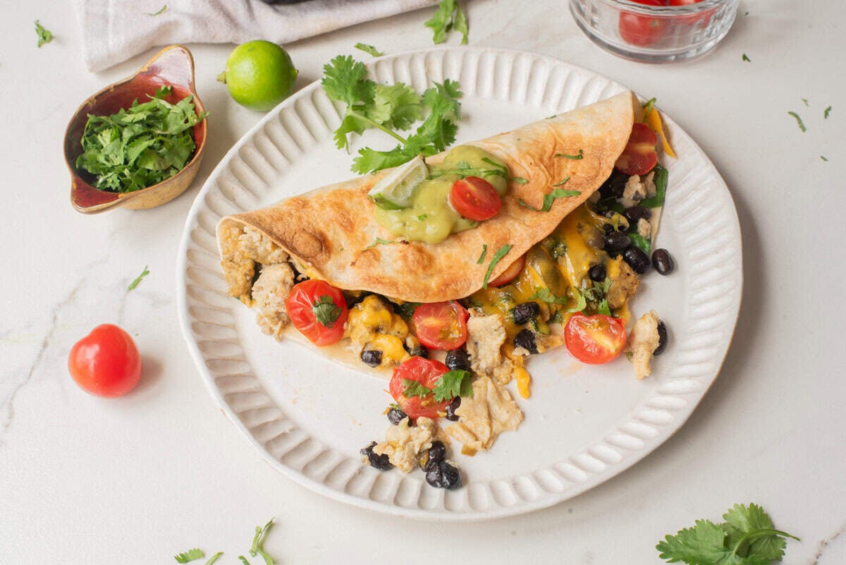 An overhead image of vegetarian breakfast quesadilla on a plate.