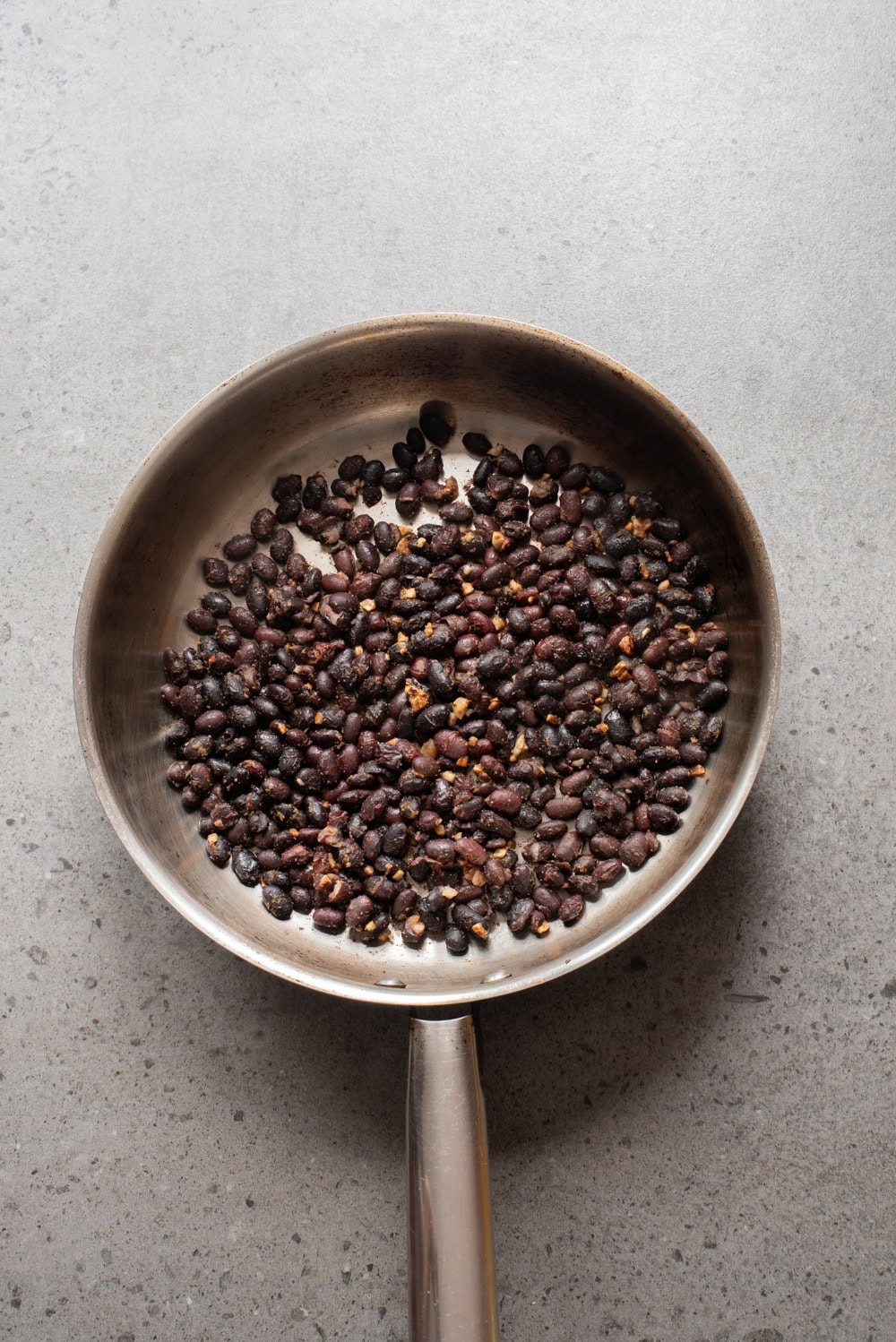 An overhead image of toasting the black beans.