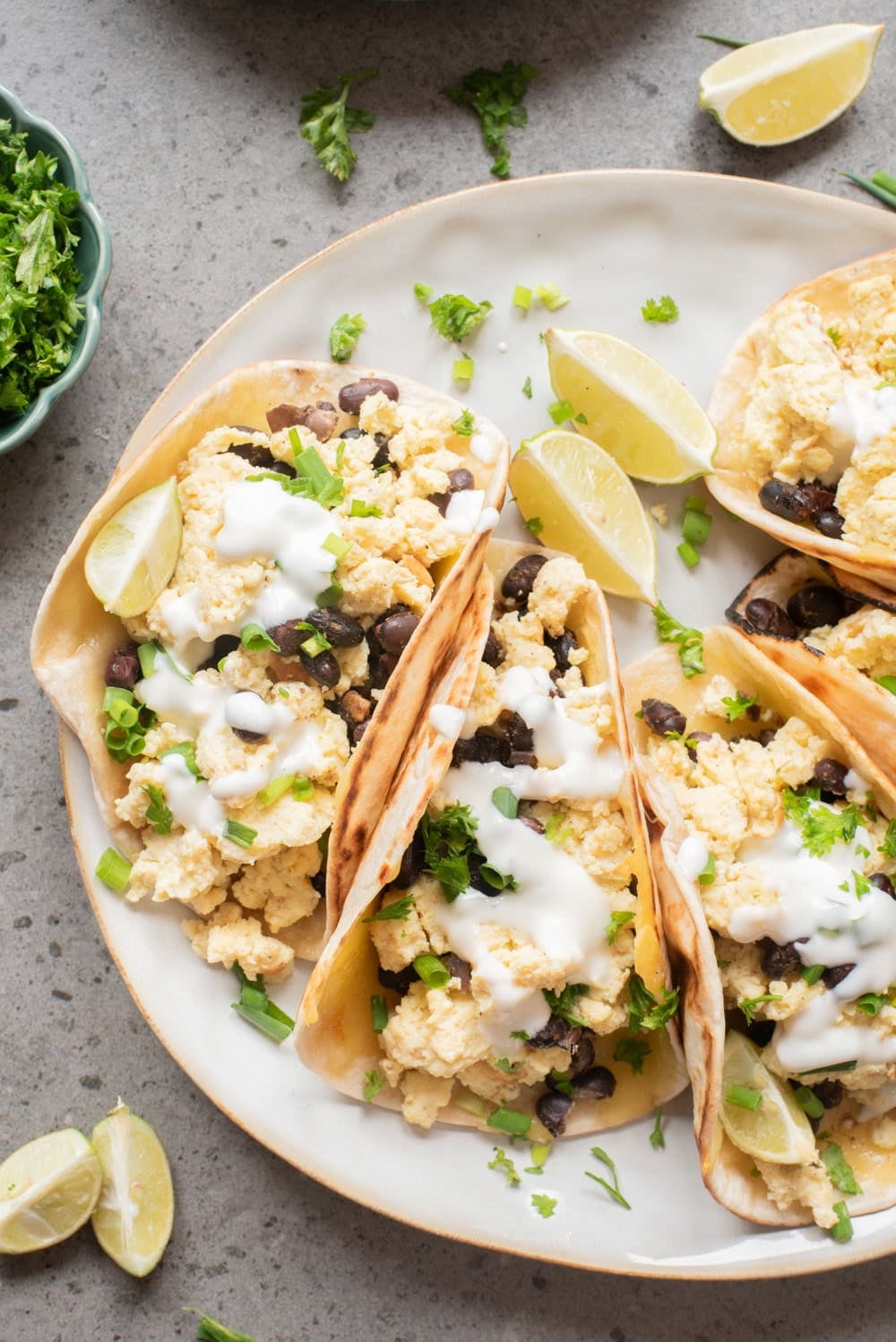 An overhead image crispy cheese breakfast tacos on a plate.