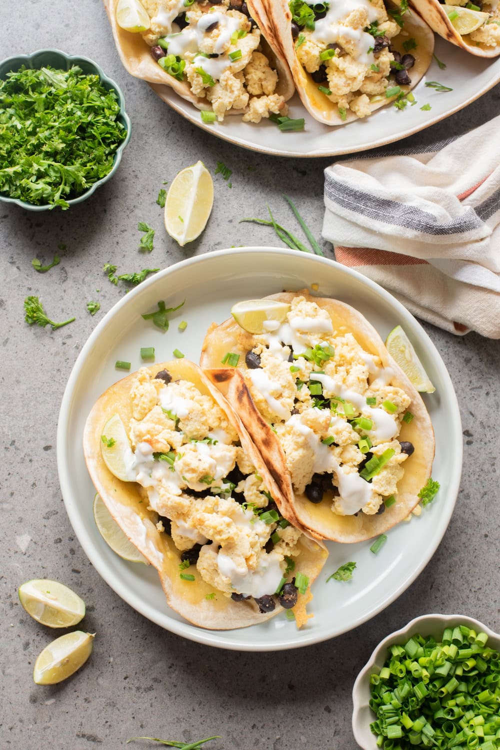 An overhead image of breakfast tacos served on a plate.