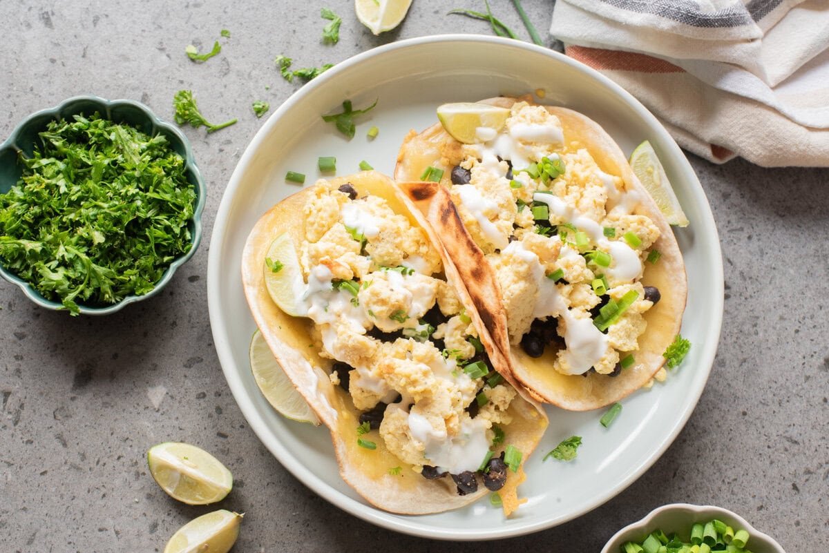 An overhead image of breakfast tacos served on a plate.