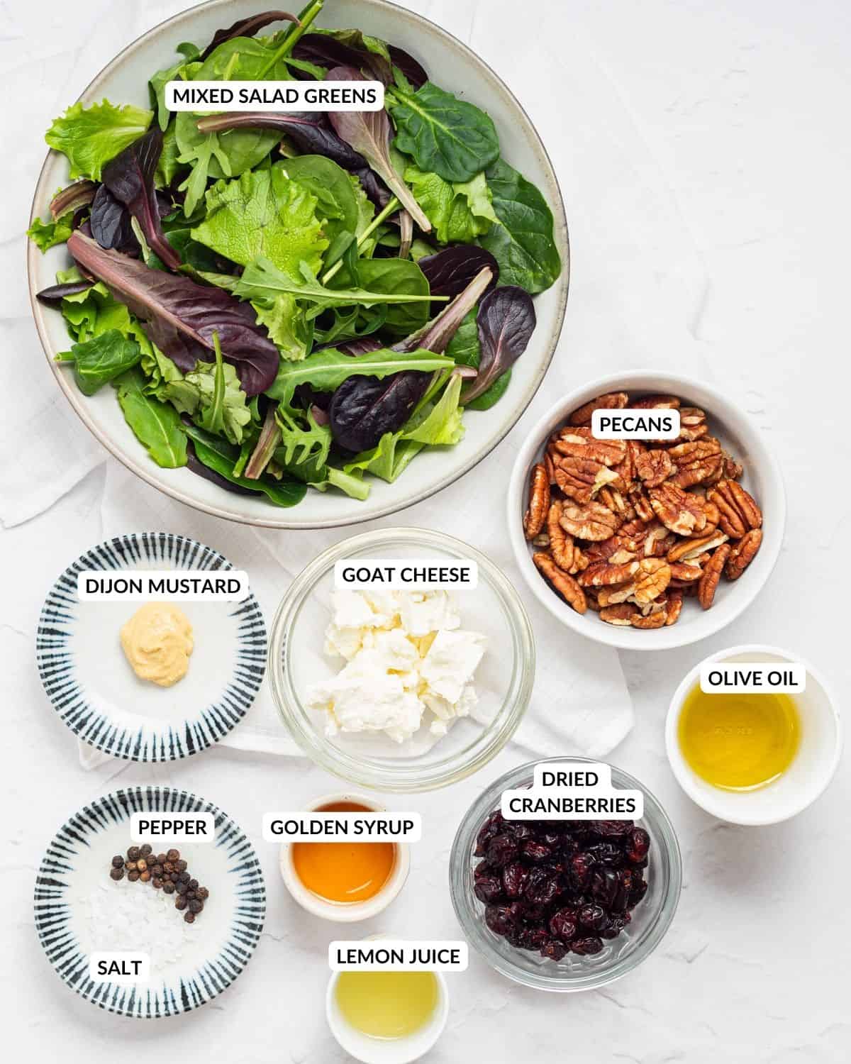 An overhead image of the ingredients of cranberry salad in separate containers and labels on each of them.