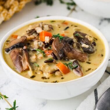 A close up image of creamy wild rice soup in a bowl.