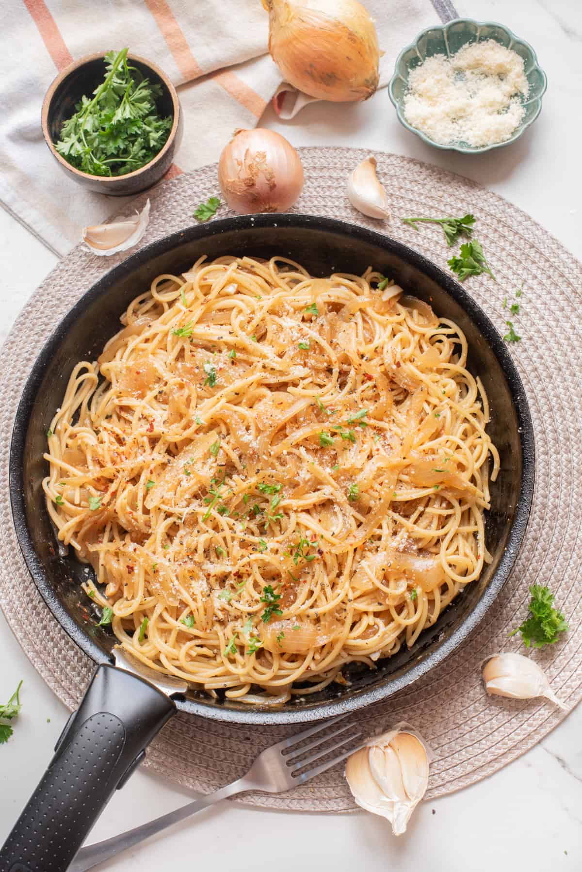 An overhead image of caramelized onion pasta on a skillet.