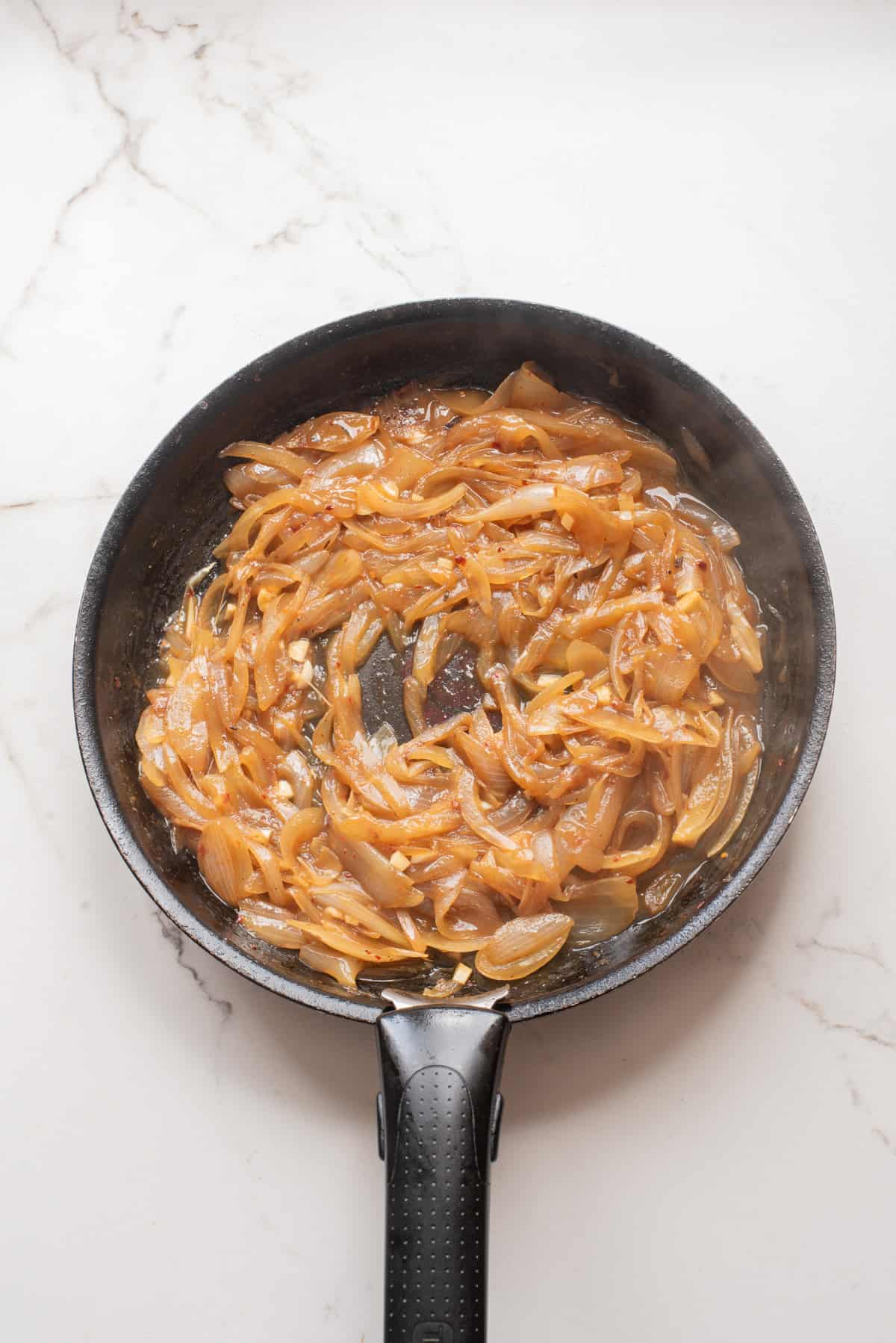 An overhead image of letting the sauce simmer to reduce the dry white wine.