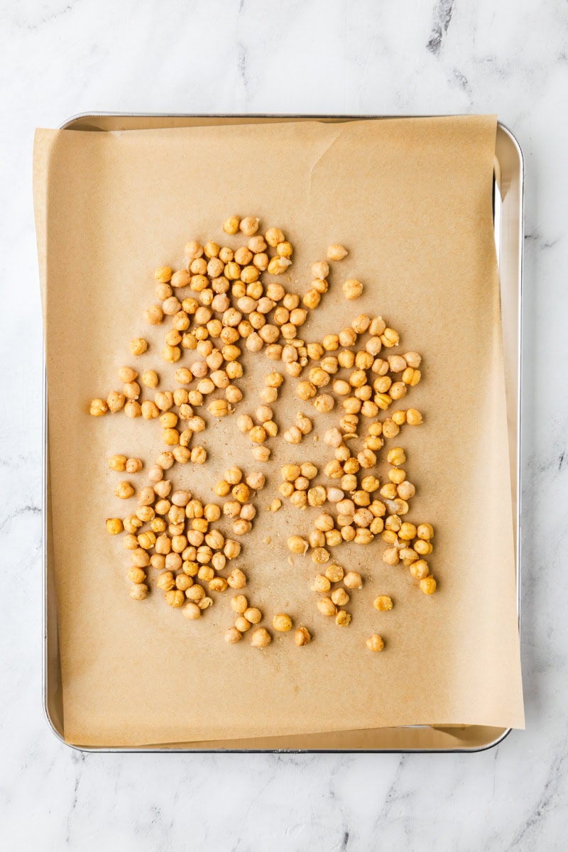An overhead image of chickpeas on a baking sheet.