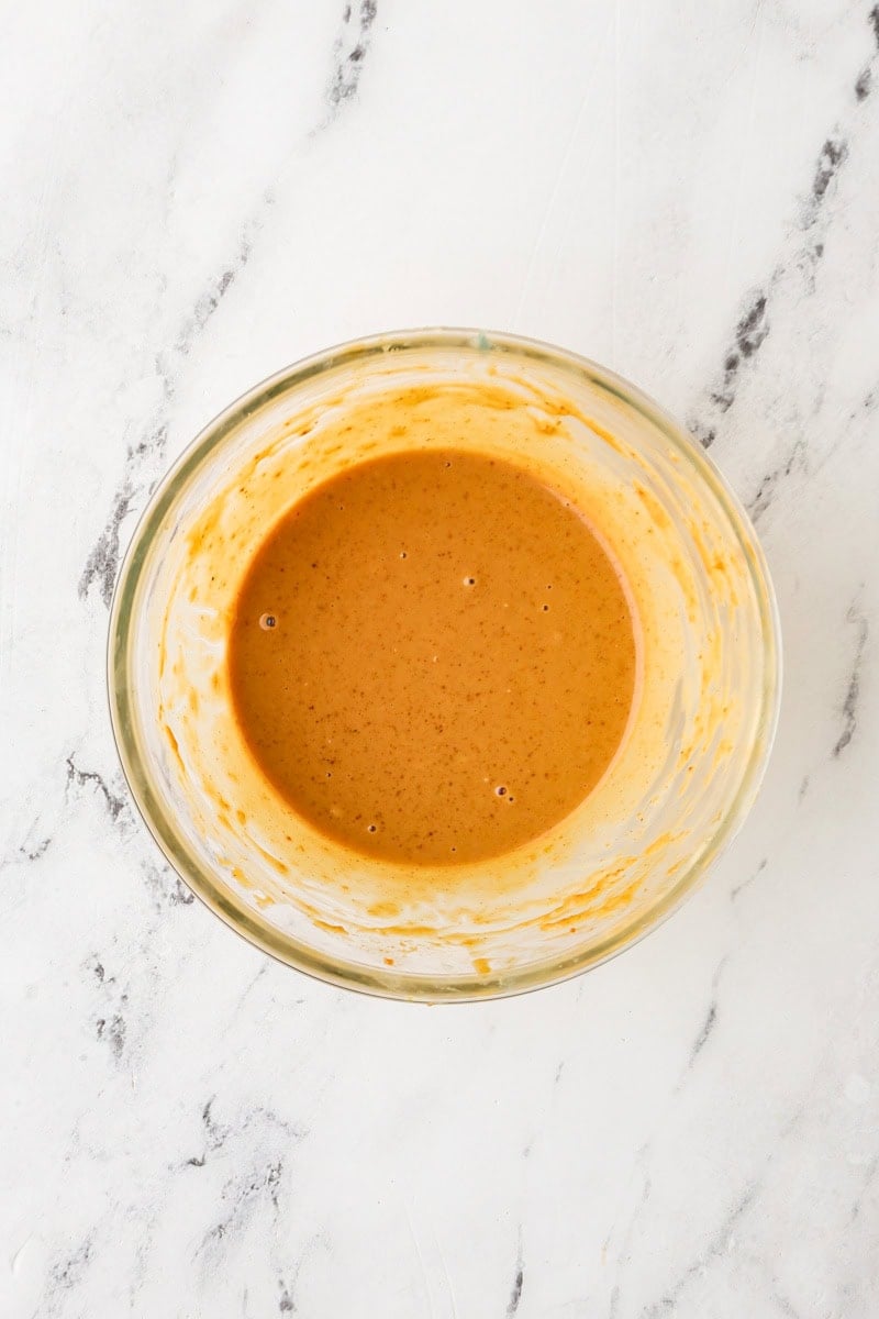 An overhead image of whisking the dressing together.