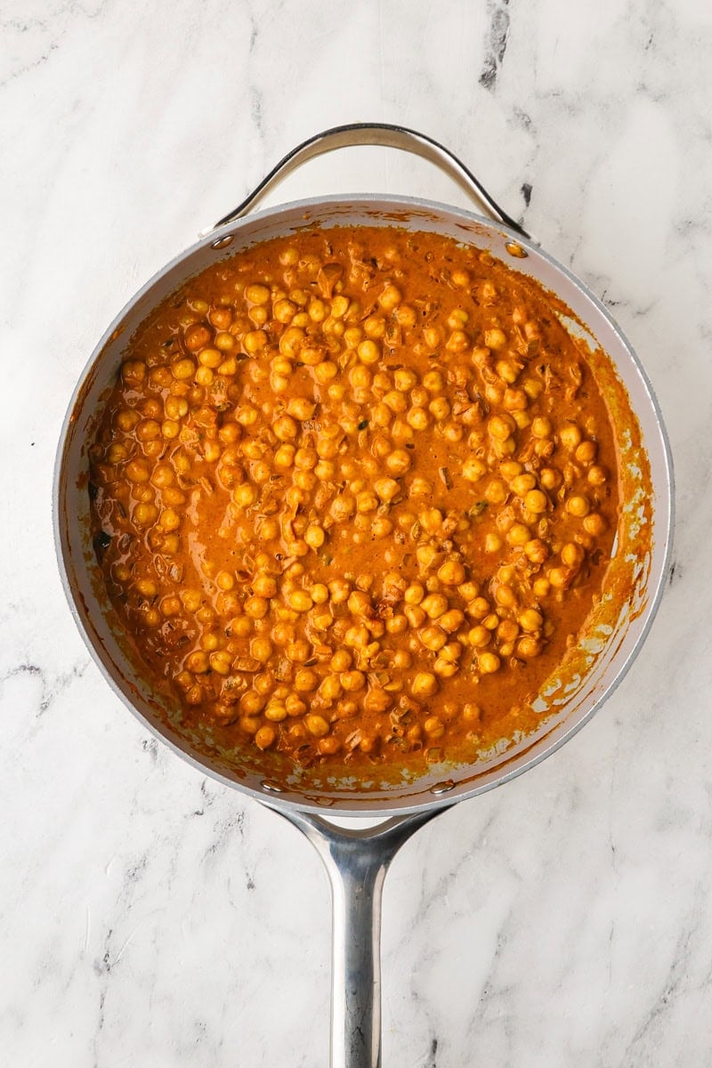 An overhead image of adding chickpeas to the mixture.