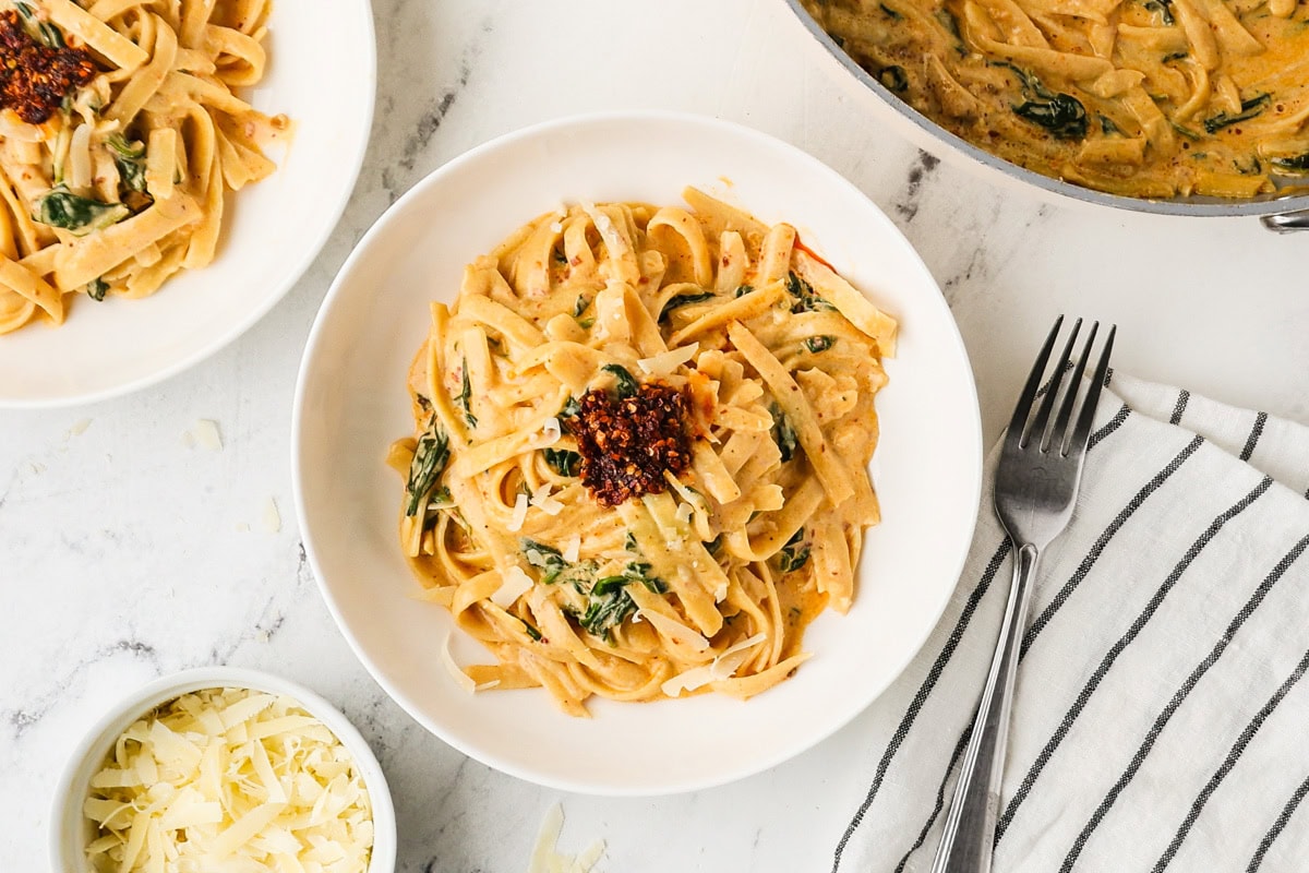 An overhead image of serving fettuccine alfredo on a plate.