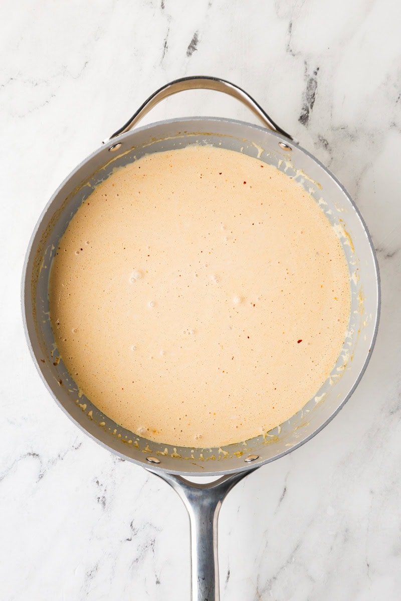 An overhead image of building the cream sauce in a pot.