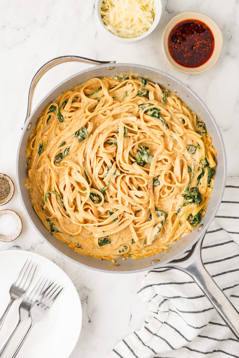 An overhead image of adding pasta to the pot.