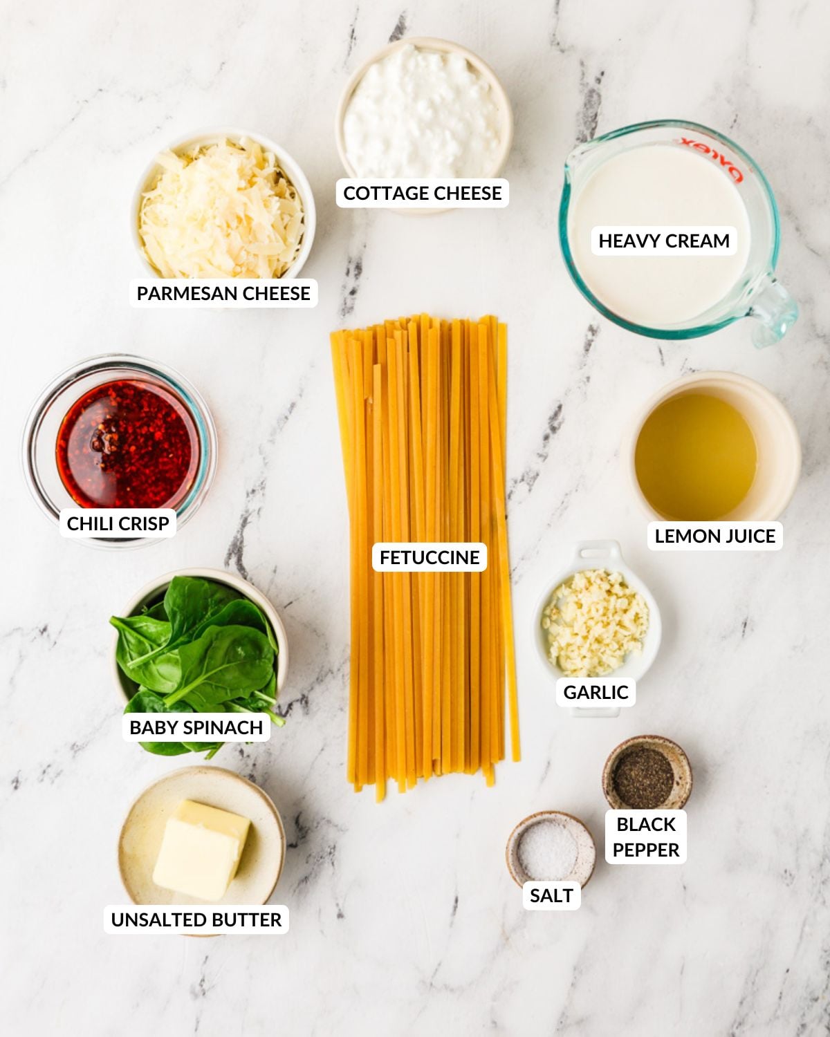 An overhead image of the ingredients of chili crisp fetuccine alfredo.