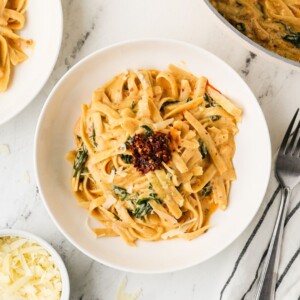 An overhead image of serving fettuccine alfredo on a plate.