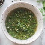 Bowl of classic Argentinian chimichurri sauce made with parsley, garlic, olive oil, and red wine vinegar.