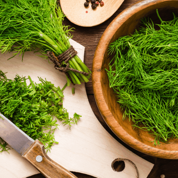 Chopped fresh dill on chopping board