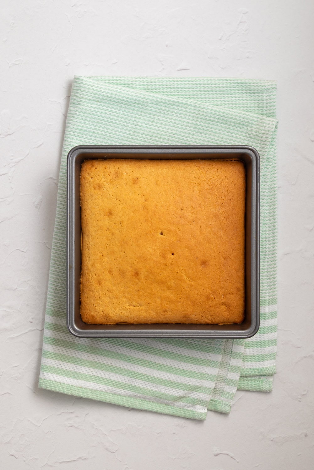 Freshly baked vanilla almond cake in a baking dish.