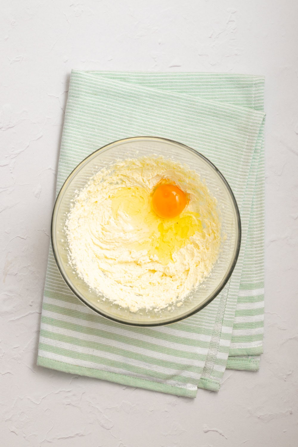Butter, sugar, eggs, and extracts mixed together for homemade vanilla-almond cake batter.