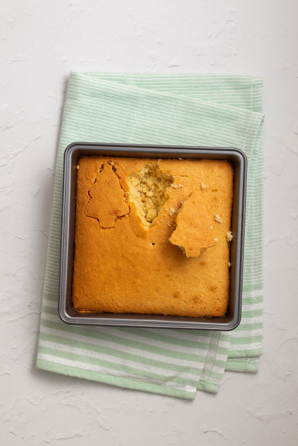 Homemade vanilla-almond cake baked and cut into a tree shape for Christmas Tree Cake Dip.
