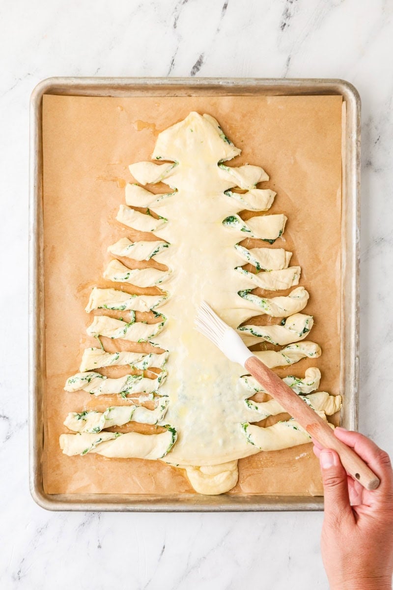 Christmas tree dough brushed with garlic butter before baking.