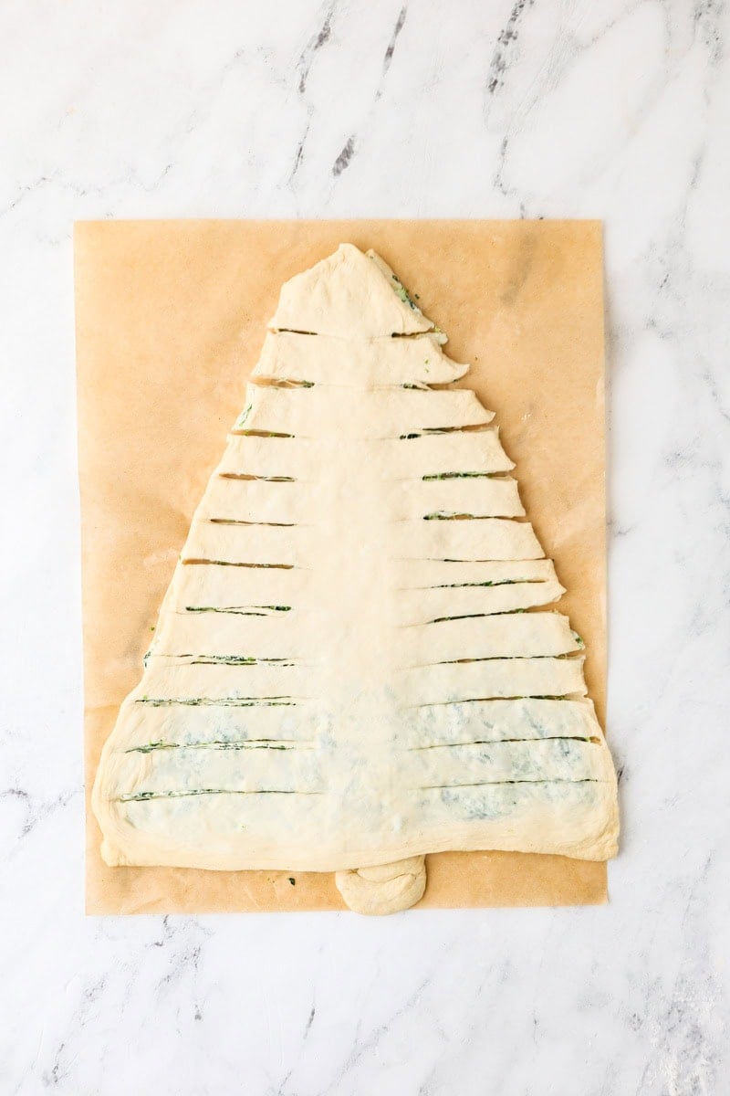 Filled Christmas tree dough cut into strips.