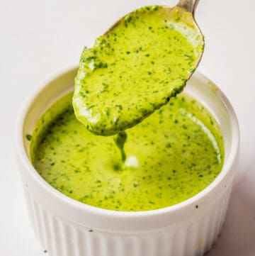 An image of a spoon scooping up a spoonful of cilantro lime dressing.
