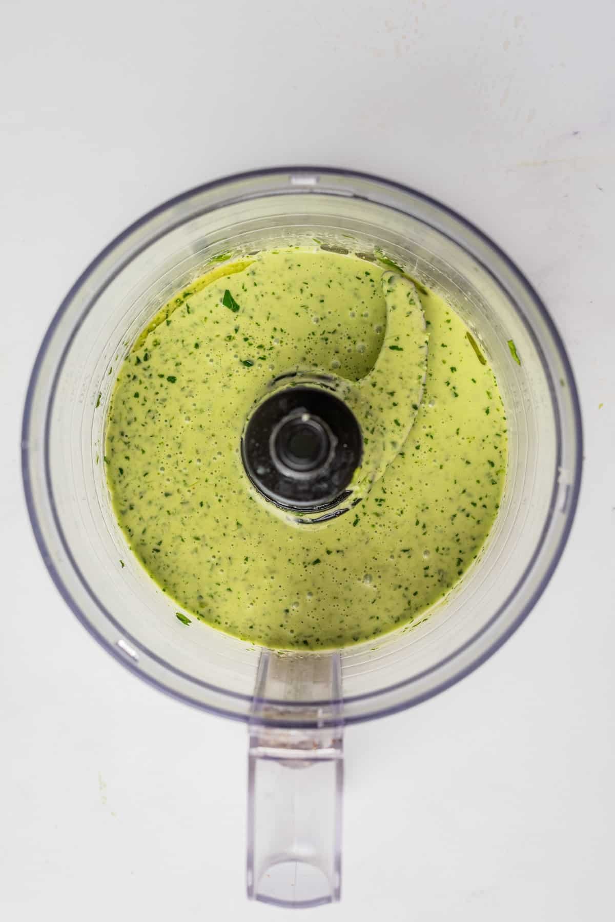 An overhead image of cilantro lime dressing after bring blended in a blender.